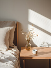 Minimal scene of a bed with sunlight and flowers