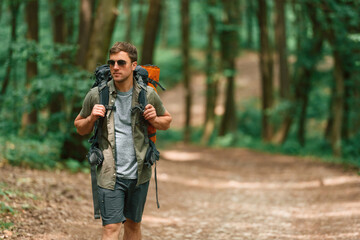 Tourist in summer forest. Conception of exploration and leisure