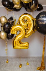 black and gold balloons in the room, numbers 29, the inscription on the balloon 