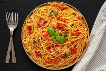 Homemade Spaghetti With Fresh Tomato Sauce on a Plate, top view. Flat lay, from above, overhead. Close-up.