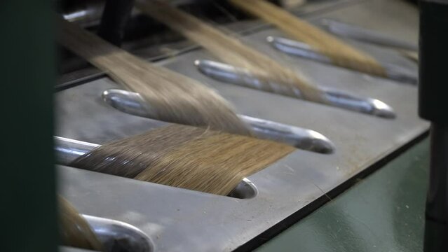 Linen production. Production process. Material processing plant. Creation of yarns and ropes. Industrial plant. A workshop with working machines. Close-up of production.