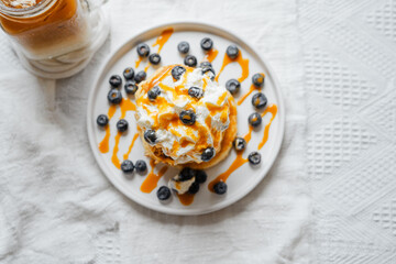 Pancakes with whipped cream and blueberries
