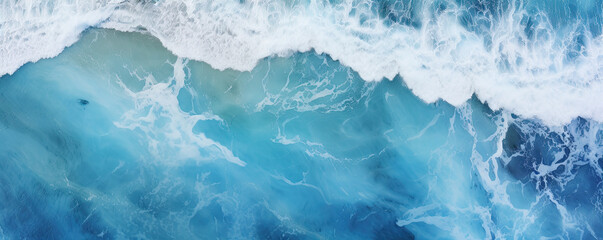 Fototapeta na wymiar Sea waves or ocean surface from aerial view. Blue water with foam, copy space for text.