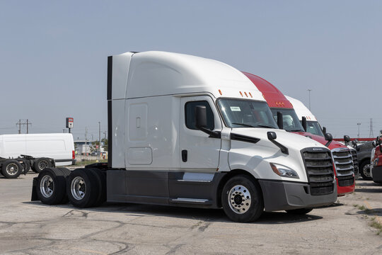 Freightliner Semi Tractor Trailer Trucks lined up for sale. Freightliner is owned by Daimler Trucks.