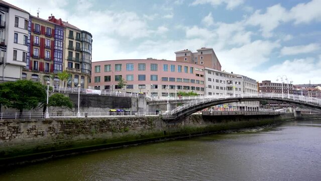 Bilbao, SPAIN - July 19 2022: City center of Bilbao. Beautiful building architecture. View of River Nervion and his promenade area. Travel destination in North of Spain. Stabilized static video.