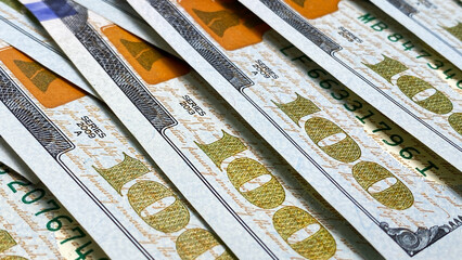 Close-up of one hundred dollar cash notes. Background of cash dollar bills. 100 US dollars. The...