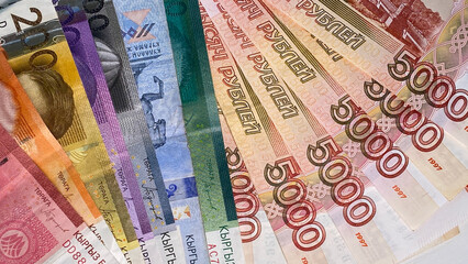 The concept of currency exchange. Banknotes of 5000 rubles and Kyrgyz money of different...