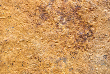stone background in ocher and brown tones. 