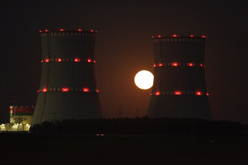 August 2022. Nuclear power plant in Belarus. Night landscape of the cooling tower against the...