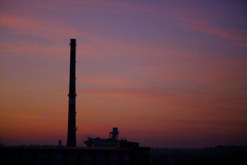 Fototapeta na wymiar Industrial pipe on the background of beautiful sunset. Evening time