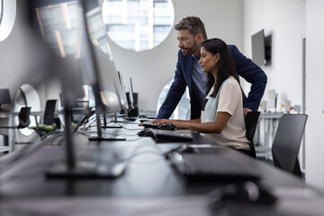 Business executives looking at a computer screen in an empty office
