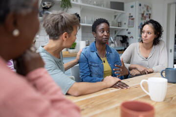 African American woman speaking in a support group being comforted