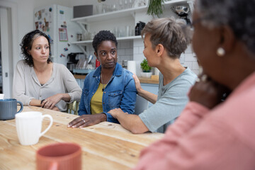 African American woman in a support group being comforted