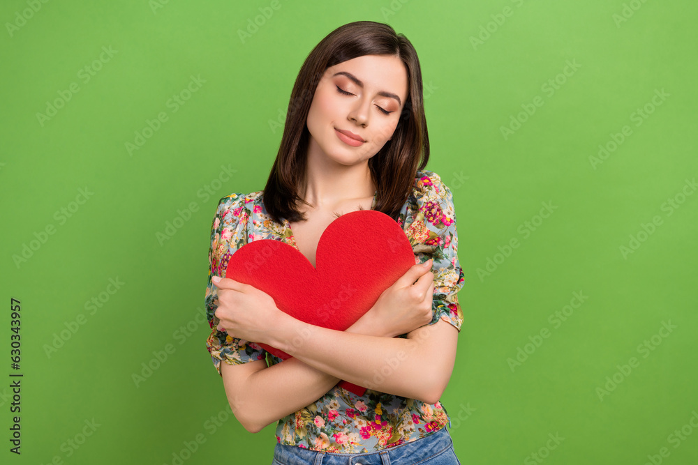 Canvas Prints Photo of cute girl wear spring flowers print blouse cuddles paper red heart post card romantic moment isolated on green color background