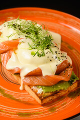 Bruschetta with red fish and eggs benedict