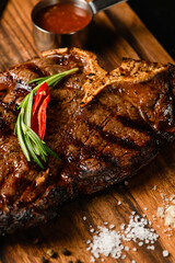 Appetizing juicy porterhouse steak on a wooden cutting board.