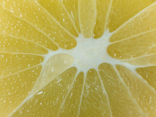 slice of juicy fresh yellow aromatic bergamot detail close-up macro. fruit background