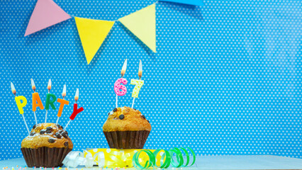 Festive muffin pie with candles for a birthday. Birthday background with numbers  67. Anniversary...