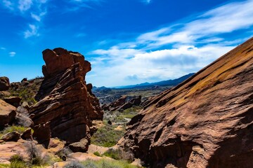 Stunning landscape featuring a range of rocky mountains silhouetted against a bright blue sky