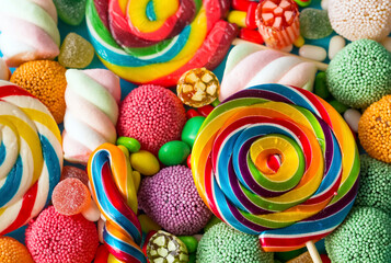 Colorful lollipops and different colored round candy. Top view.