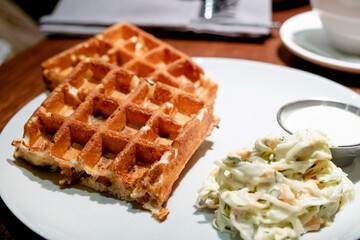 Belgian waffles with eggs and bacon. Breakfast in cafe