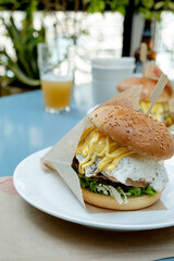eating delicious burger at the cafe