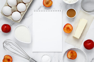 Ingredients for making classic cake pie with plums on white background. Concept homemade food, seasonal pastries. Top view, copy space