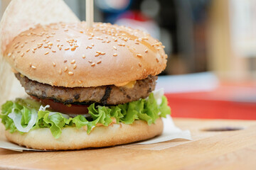 eating delicious burger at the cafe
