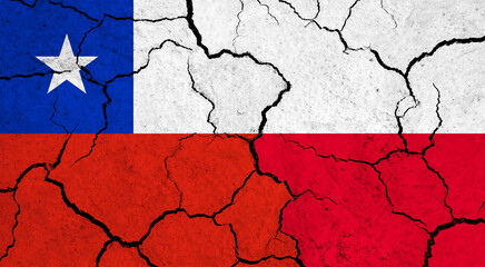 Flags of Chile and Poland on cracked surface - politics, relationship concept