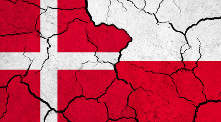 Flags of Denmark and Poland on cracked surface - politics, relationship concept