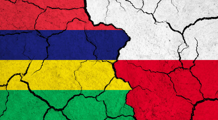 Flags of Mauritius and Poland on cracked surface - politics, relationship concept
