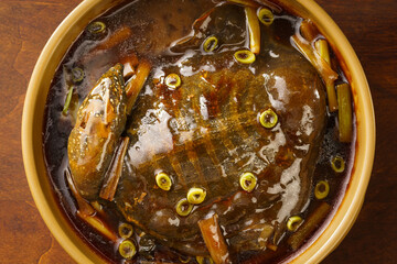 Special Chinese food Braised soft-shelled turtle with scallions on a dark vintage background