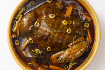 Braised soft-shelled turtle with scallions on pure white background