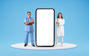 Doctors pointing at huge phone with white empty screen
