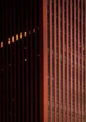 an outside photo of a building at night time with one large light shining