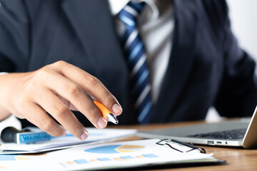 Audit or Businessman using hand to working by digital tablet, checking document legal prepare paperwork, report for analysis TAX time, accountant Documents data contract partner deal in desk.