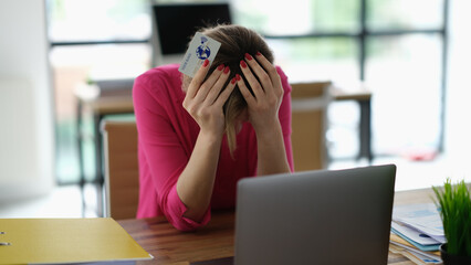 Worried woman having trouble shopping online using credit card and laptop. Theft of money from bank...