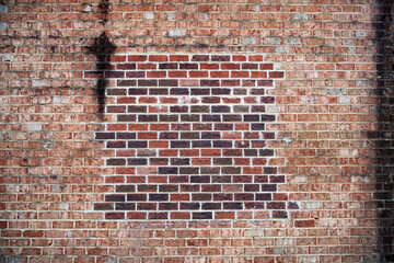 brick wall, old red brick background with new brick patch.
