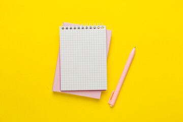 Notebooks with stationery on color background, top view