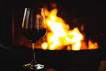 Wine glass and fire on the background