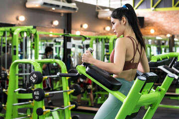 Sexy sportswoman doing exercise in fitness gym sport club