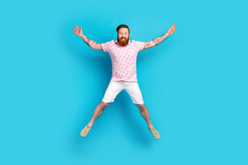 Fototapeta na wymiar Full size portrait of overjoyed nice person jumping raise hands make star figure isolated on blue color background