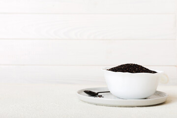 quinoa seeds in bowl on colored background. Healthy kinwa in small bowl. Healthy superfood