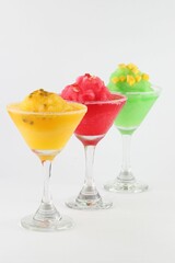 Delightful martini glasses filled with different colored cocktails, all frosted with condensation