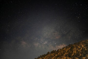 Our Galactic home rising over a volcanic peak