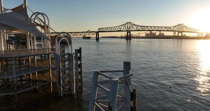 Beautiful view of a coast and Mississippi River Bridge on the other side at sunset