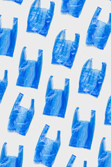 Minimal trend pattern of blue plastic bags on light background, Biodegradable packaging waste, Disposable bag for grocery or garbage, bag free day. polythene packets. Plastic free concept