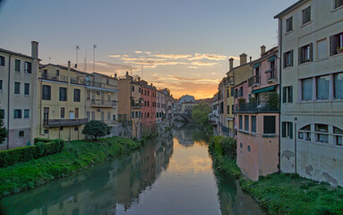 Fototapeta na wymiar Twilight Romance in Padua Canal at Sunset