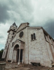 Fototapeta na wymiar Low angle of Pilar Church in Monte Mario, Spain on a cloudy day