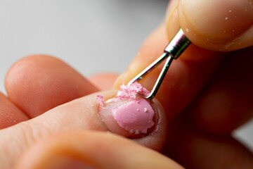 Procedure of removing gel polish from nails.